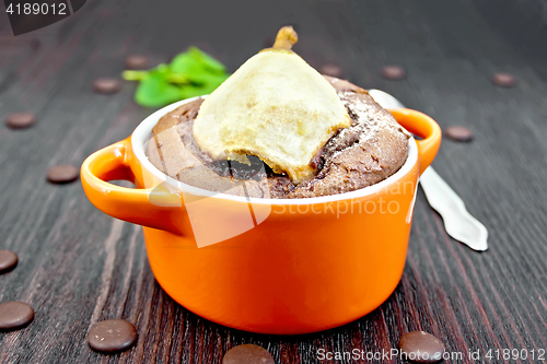 Image of Cake with chocolate and pear in bowl on board