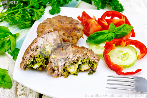 Image of Cutlets stuffed with vegetables in plate on board