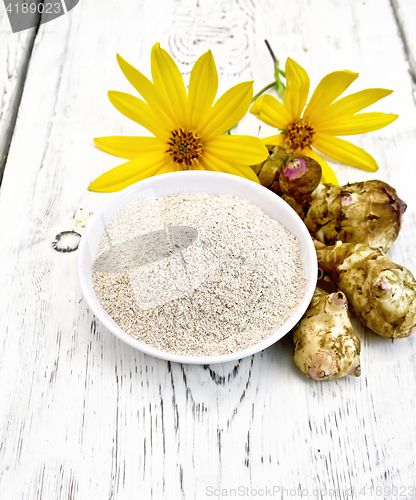 Image of Flour of Jerusalem artichoke in bowl with vegetables on board