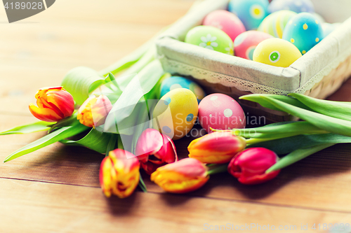 Image of close up of colored easter eggs and flowers