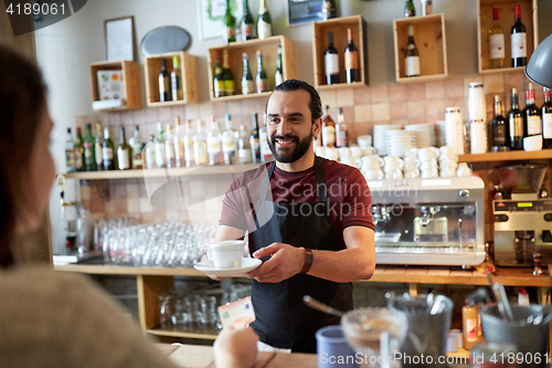 Image of man or waiter serving customer at coffee shop