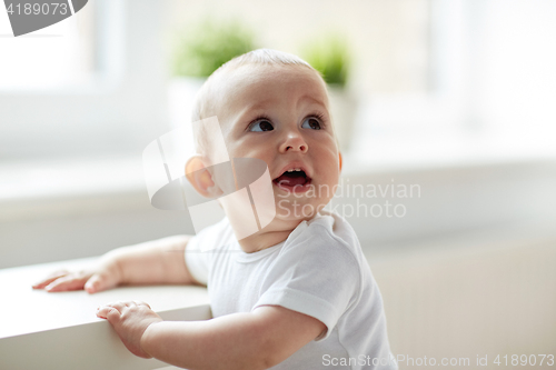 Image of happy little baby boy or girl at home