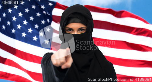 Image of muslim woman in hijab pointing finger to you