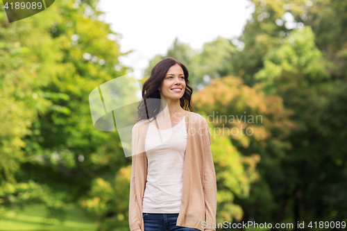Image of beautiful happy young woman in summer park