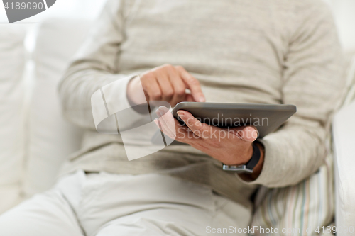 Image of close up of senior man with tablet pc at home