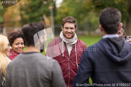 Image of group of happy international friends outdoors