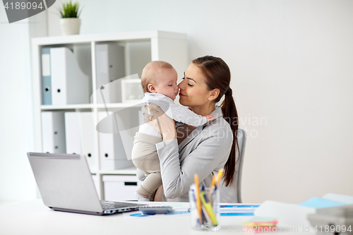 Image of happy businesswoman with baby and laptop at office