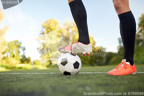 Image of soccer player playing with ball on football field