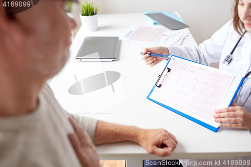 Image of doctor showing cardiogram to old man at hospital