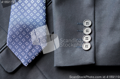 Image of close up of business suit jacket and tie