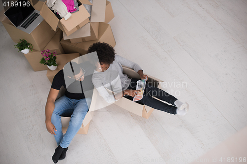 Image of African American couple  playing with packing material