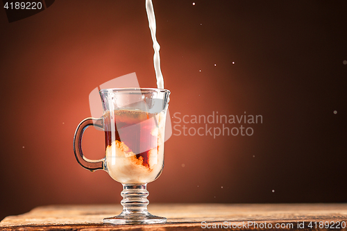 Image of Adding milk to a cup of tea