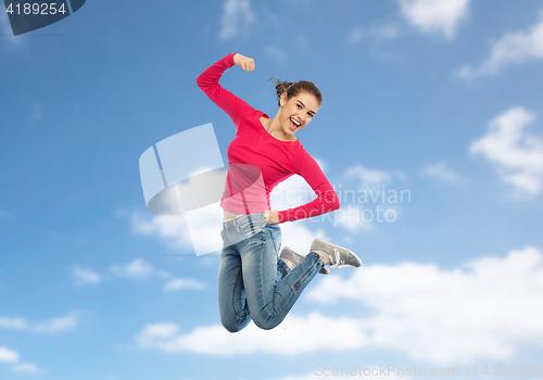 Image of smiling young woman jumping in air