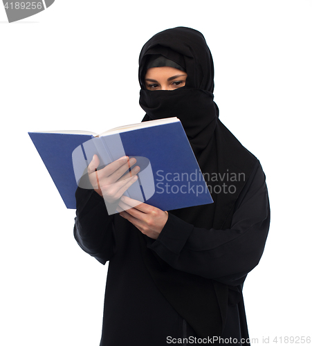 Image of muslim woman in hijab reading book over white