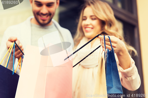 Image of close up of couple with shopping bags on street