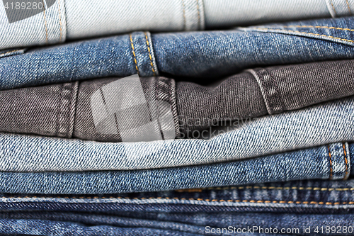 Image of close up of denim clothes or jeans pile