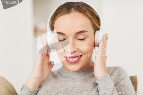 Image of woman with headphones listening to music at home