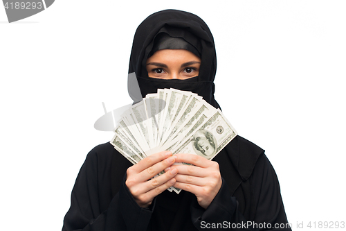 Image of muslim woman in hijab with money over white