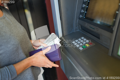 Image of close up of hand withdrawing money at atm machine