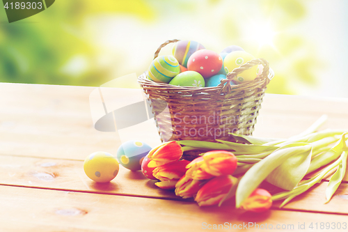 Image of close up of easter eggs in basket and flowers