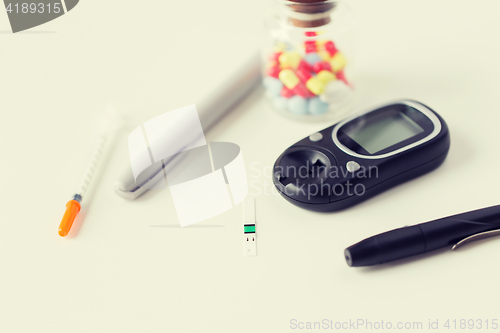 Image of close up of blood sugar test stripe and glucometer