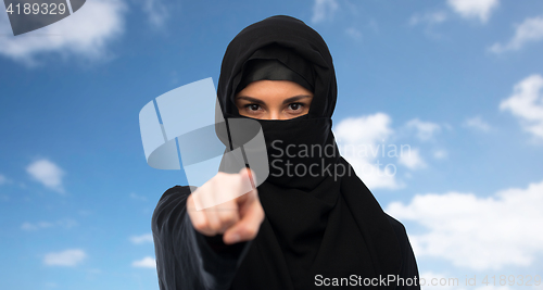 Image of muslim woman in hijab pointing finger to you