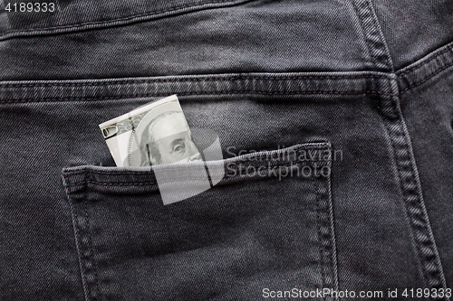 Image of dollar money in pocket of denim pants or jeans