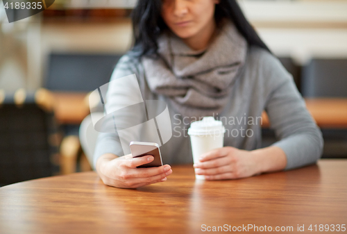 Image of close up of woman with smartphone and coffee