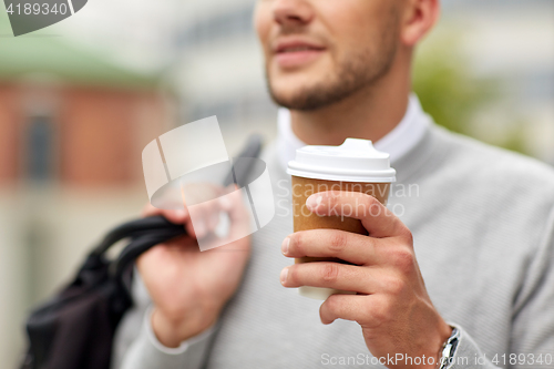 Image of close up of man with coffee cup on street