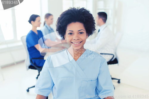 Image of doctor or nurse over group of medics at hospital