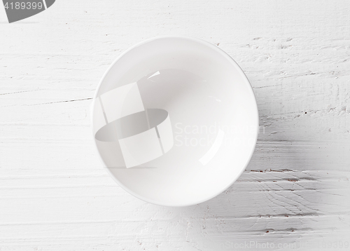 Image of empty bowl on white wooden table