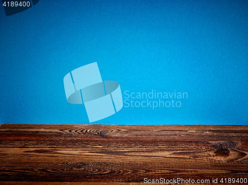 Image of wooden board and blue background