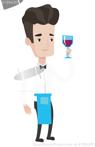 Image of Bartender holding a glass of wine in hand.