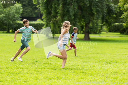 Image of group of happy kids or friends playing outdoors