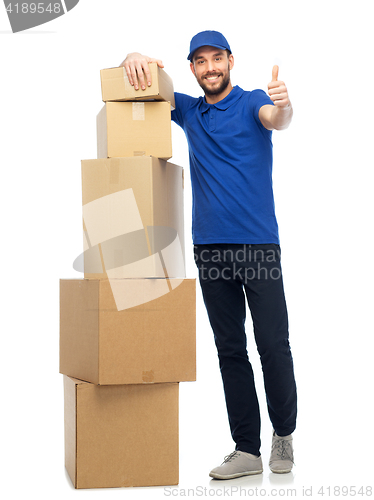 Image of happy delivery man with boxes showing thumbs up