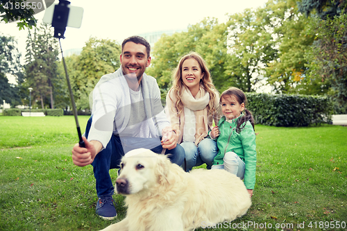 Image of happy family with dog taking selfie by smartphone