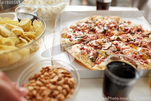 Image of pizza and other fast food snacks on table