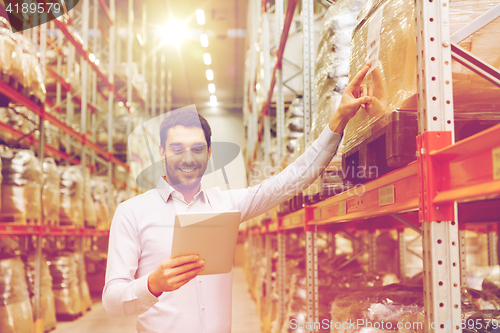 Image of happy businessman with tablet pc at warehouse