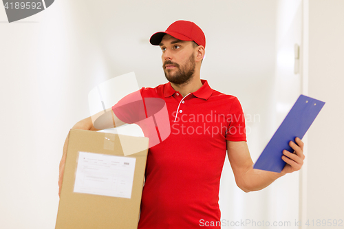 Image of delivery man with box and clipboard in corridor