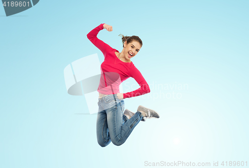 Image of smiling young woman jumping in air