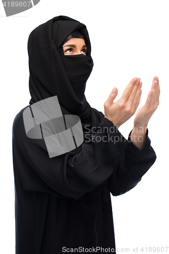 Image of praying muslim woman in hijab over white
