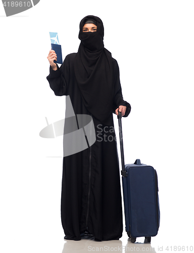 Image of muslim woman with ticket, passport and travel bag