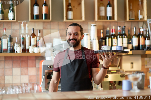 Image of happy man or waiter with coffee and sugar at bar