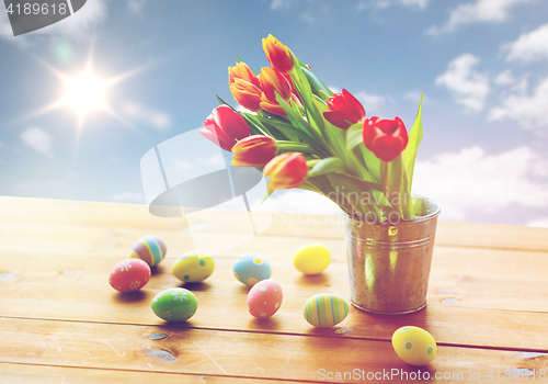 Image of close up of easter eggs and flowers in bucket