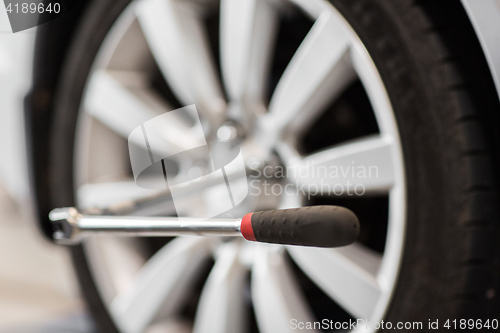 Image of screwdriver and car wheel tire