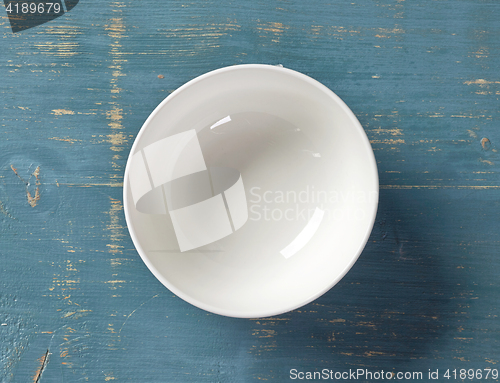 Image of white bowl on blue wooden table