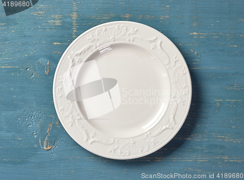 Image of white plate on blue wooden table