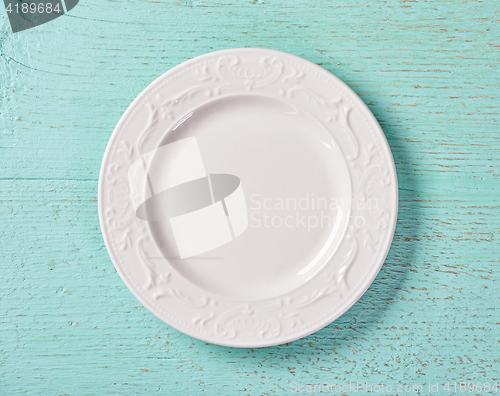 Image of white plate on blue background