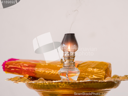 Image of Oil lamp and joss sticks at temple in Thailand