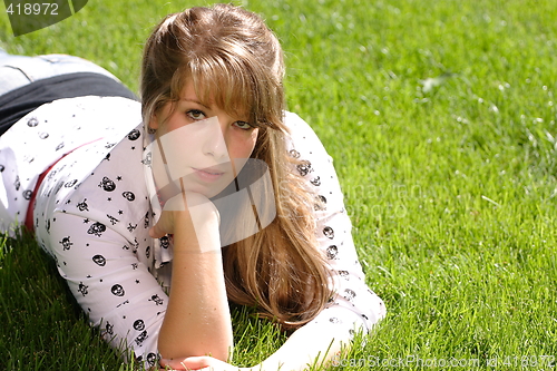 Image of Serious Teenage Girl in the Grass